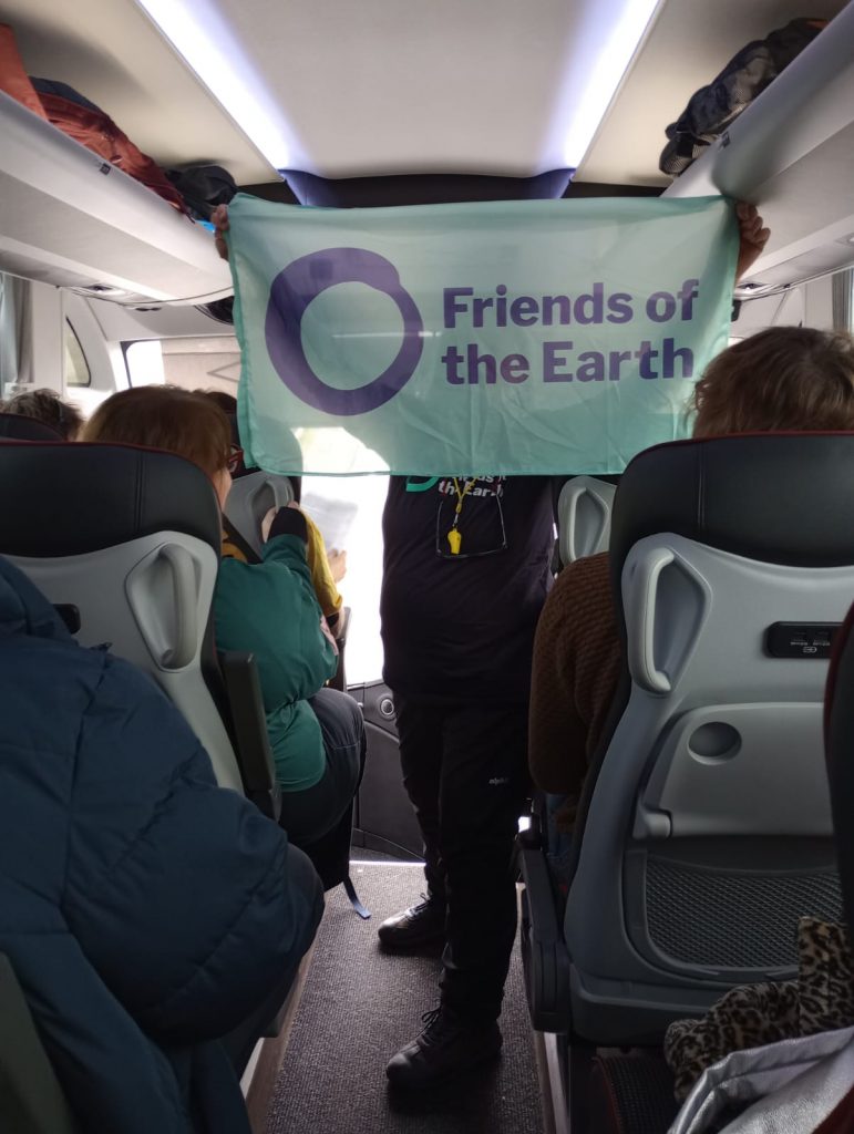 Friends of the Earth banner on the coach going from Rushmoor to London